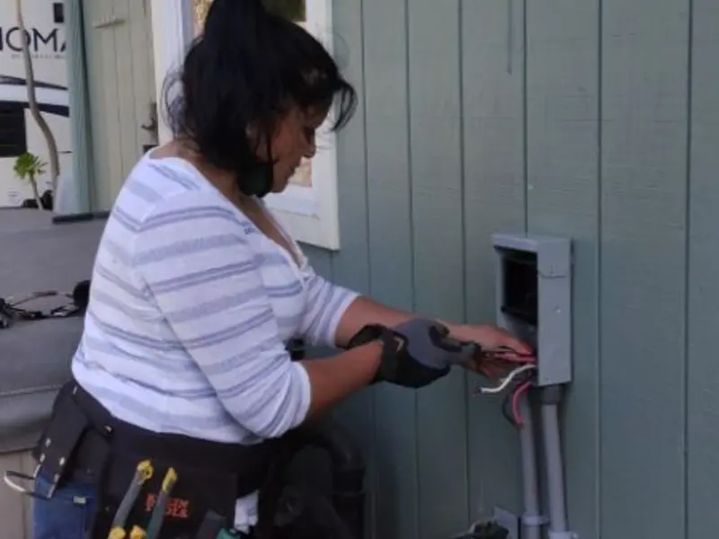 Licensed electrician wiring an exterior subpanel in Sedro-Woolley